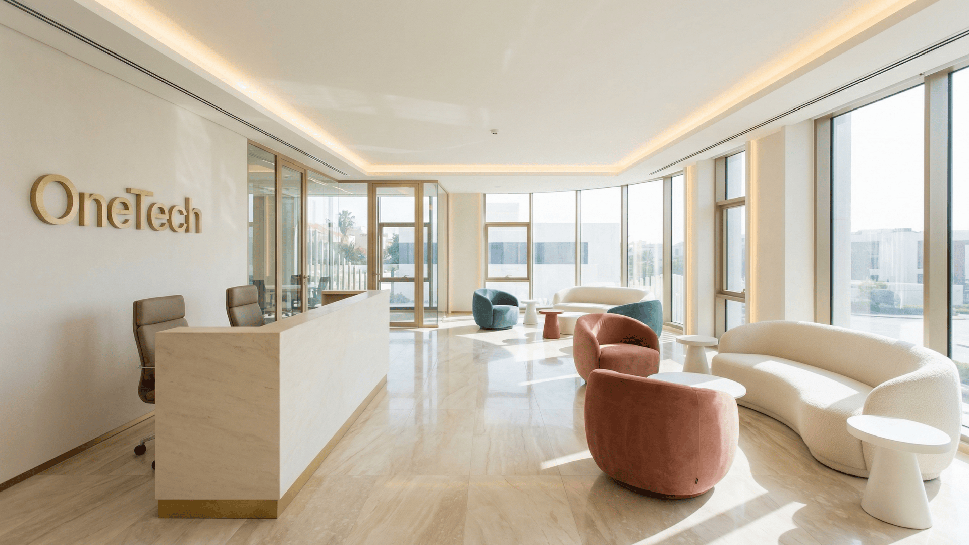 SpaceForge commercial office fit-out Dubai — OneTech office reception showing a white reception desk with gold lettering, open-plan lounge with colourful curved chairs and full-height glazed curtain wall