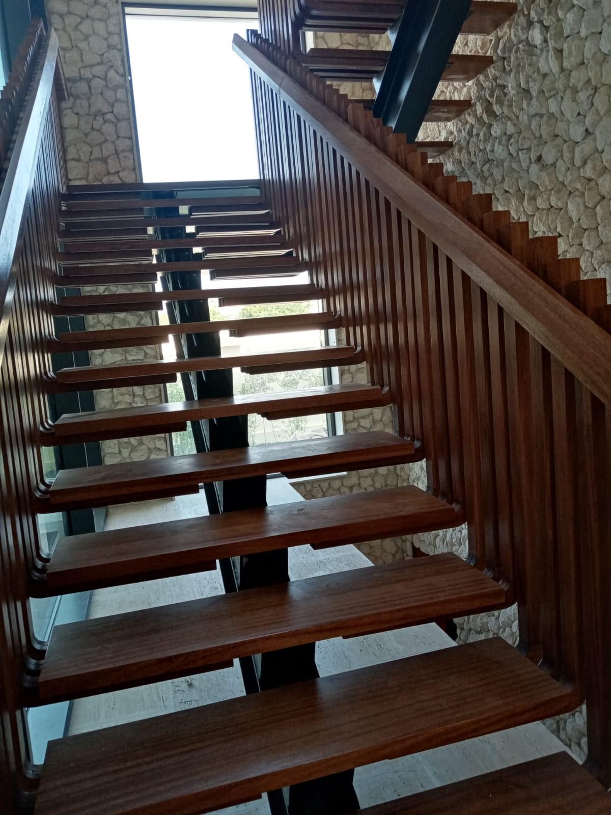 SpaceForge bespoke joinery service Dubai, custom-crafted open-tread timber staircase with hardwood steps and spindle railing