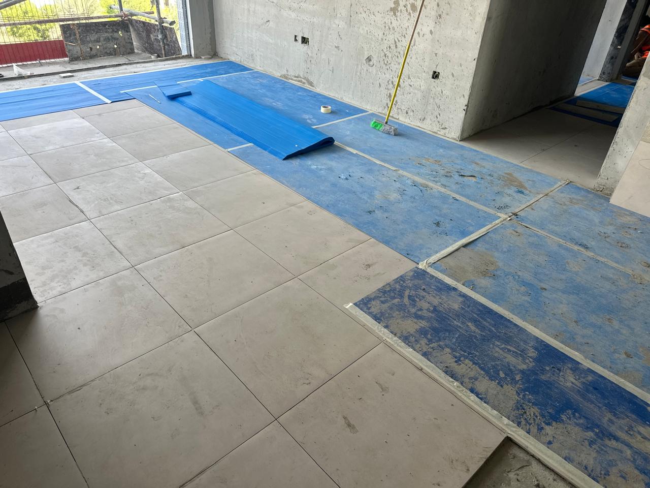 SpaceForge exterior fit-out Dubai, outdoor terrace stonework installation with protective covering on newly laid tiles at a villa project